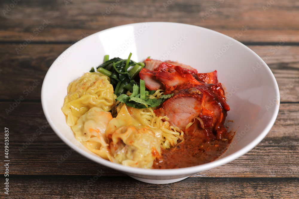 Shrimp dumpling with roasted pork with local thai tom yum spicy sauce on wood background Shrimp dumpling with roasted pork with local thai tom yum spicy sauce on wood background