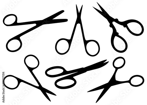 Opened manicure scissors in a set.