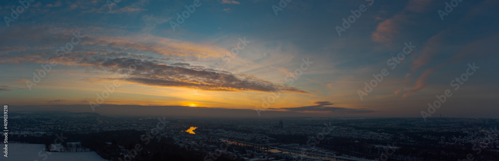 Aerial drone panorama of Regensburg in Bavaria with snow during sunrise on clear cold winter day