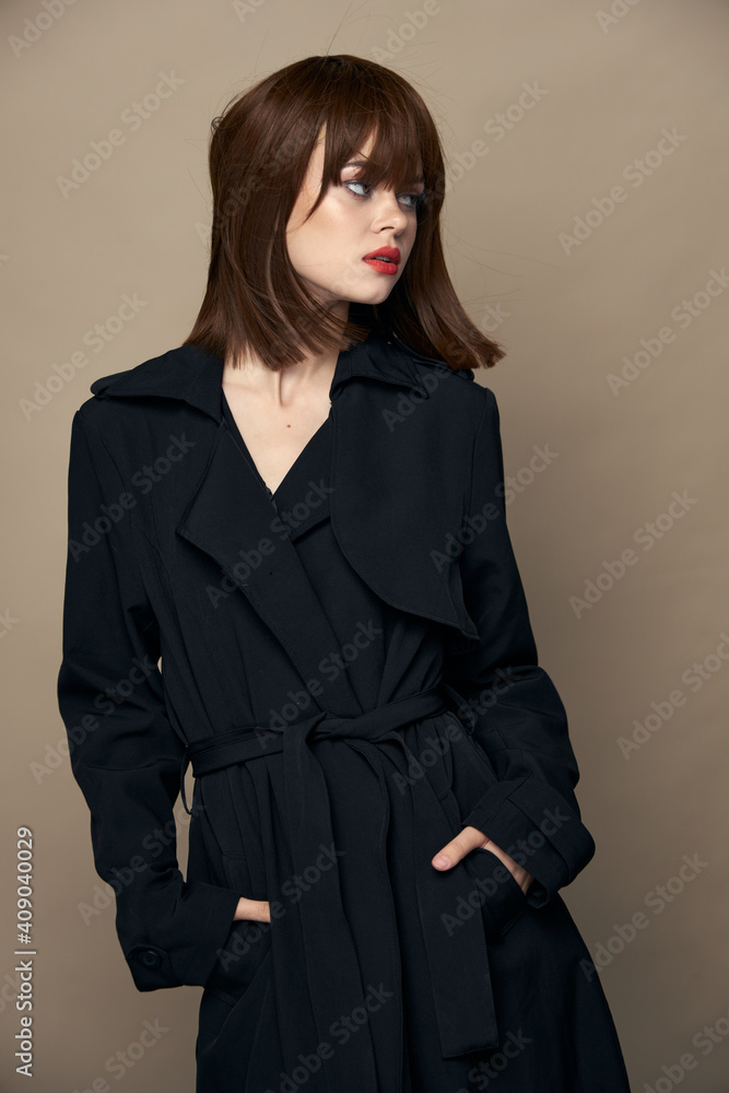Elegant woman black coat bright makeup smiling indoors Elegant woman black coat bright makeup smiling indoors