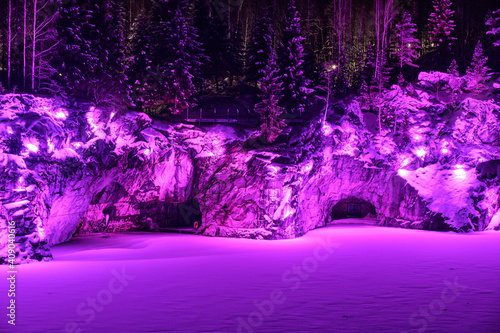 Beautiful purple illumination of a marble canyon at winter night. Ruskeala  Karelia.