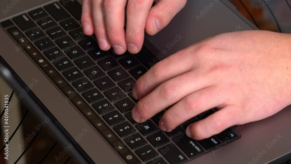 Close up male hands working on laptop in home office Close up male hands working on laptop in home office