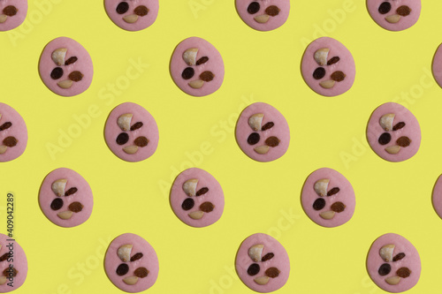 Trendy pattern of pink chocolate with nuts on bright background