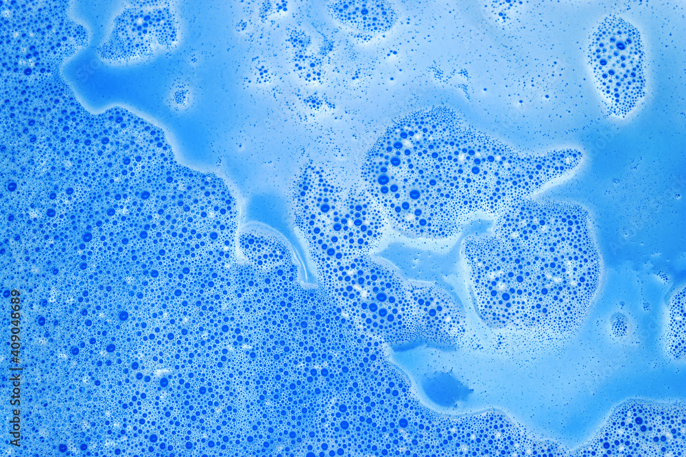 Blue foam with bubbles after dissolving color bath bomb in water. Marble texture effect. Beauty and luxury background. Abstract art. Flat lay, top view, directly above Blue foam with bubbles after dissolving color bath bomb in water. Marble texture effect. Beauty and luxury background. Abstract art. Flat lay, top view, directly above