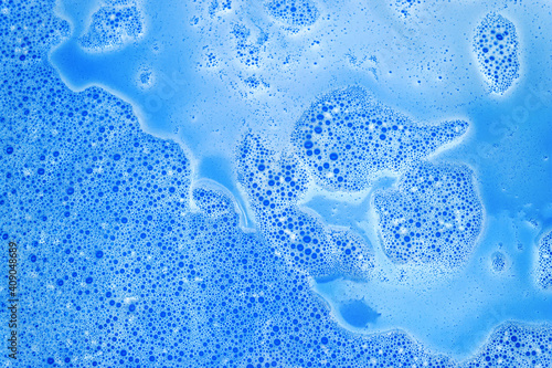 Blue foam with bubbles after dissolving color bath bomb in water. Marble texture effect. Beauty and luxury background. Abstract art. Flat lay, top view, directly above