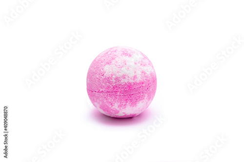 Aroma pink bubbling round bright bath bomb isolated on a white background. Close-up of bath salts