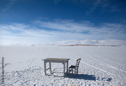 An old white table and a white chair stands on the frozen lake. There is a thin layer of snow.
Çıldır Lake in Kars frozes every winter. This is one of the important tourism destination in Turkey. photo