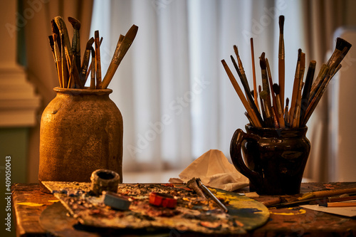 Different artist's accessories on table with background