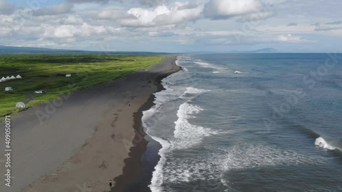 Flying over Khalaktyrsky beach with black sand on Kamchatka peninsula photo