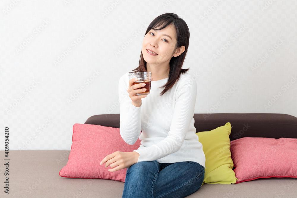 Woman drinking tea on the sofa Woman drinking tea on the sofa
