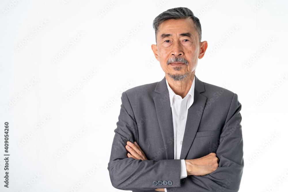 A senior Asian businessman in a classic gray suit shirt is happy, smiles, and proud. He has Crossed his arms with two hands. Studio shot over white background. Elderly, Positive and vision Concept A senior Asian businessman in a classic gray suit shirt is happy, smiles, and proud. He has Crossed his arms with two hands. Studio shot over white background. Elderly, Positive and vision Concept