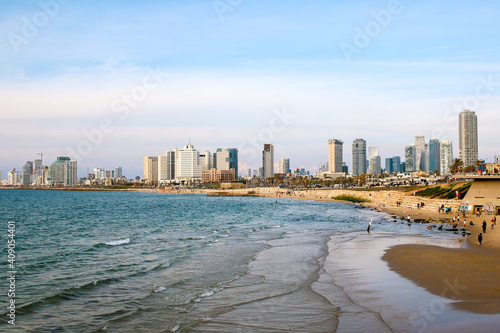 Summer day in sunny Jaffa with panoramic landscape view to new high buildings of Tel Aviv. Modern architecture on the seaside of Tel Aviv downtown on sunny day with blue sky background.