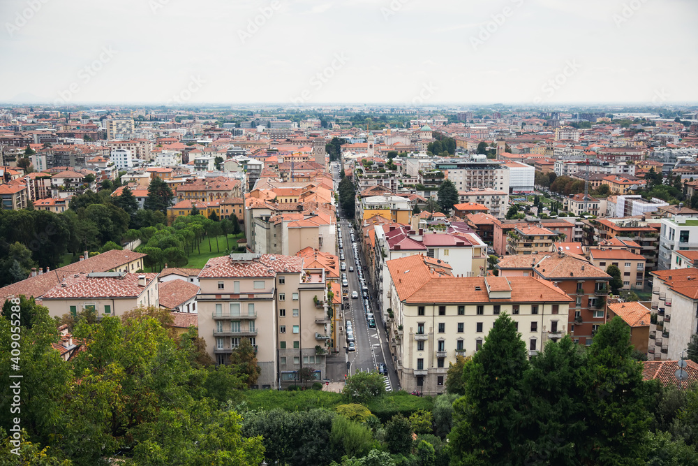 Top view of houses, roofs, road and streets of old Italian city. City panorama, tourism.