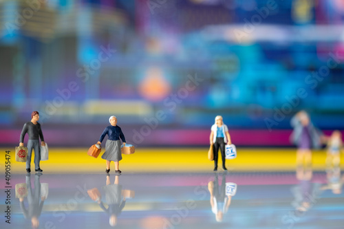 Miniature people : Tourists and shoppers stand behind the scenes of the technology city.