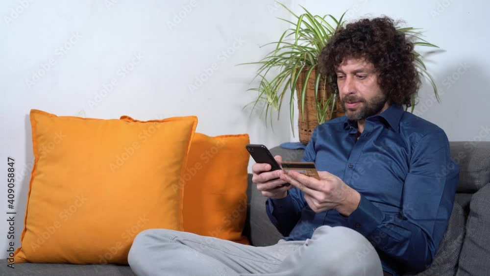 40-year-old man makes online purchases by paying with credit card from home during Covid-19 Coronavirus lockdown quarantine home 40-year-old man makes online purchases by paying with credit card from home during Covid-19 Coronavirus lockdown quarantine home