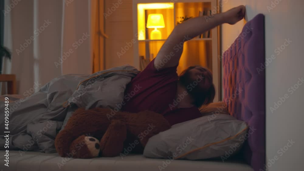 Young man banging on wall and cannot sleep because of neighbors fighting Young man banging on wall and cannot sleep because of neighbors fighting
