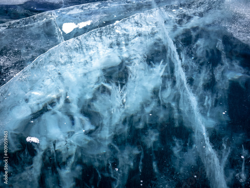 Network of cracks in thick solid layer of ice of a frozen Baikal lake in Siberia (Russia)