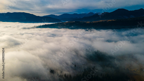 mountains tops high above clouds fog