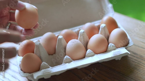 Close up hand taking eggs out of package, Fresh eggs from store packaging