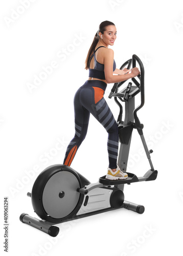 Woman using modern elliptical machine on white background