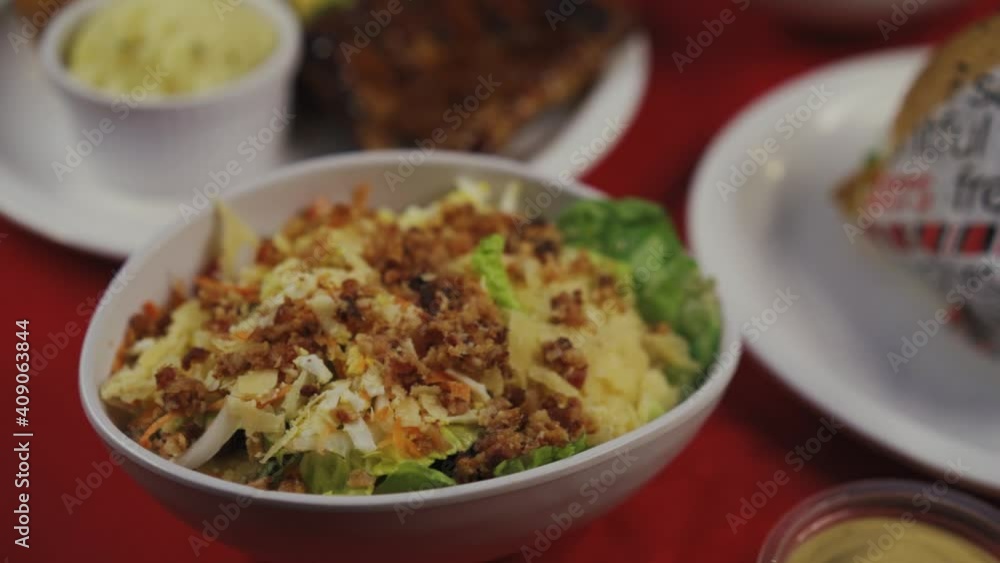 Bowl Of Ceasar Salad Garnish With Fried Chopped Bacons. - close up Bowl Of Ceasar Salad Garnish With Fried Chopped Bacons. - close up