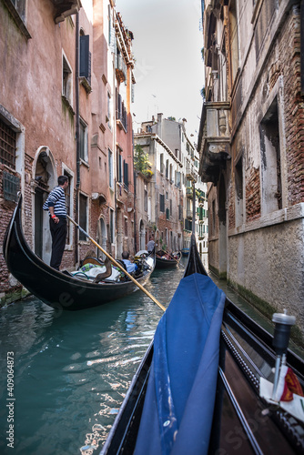 The gondolier floats on a gondola with tourists
