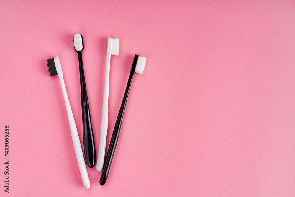 Fashionable toothbrush with soft bristles. Popular toothbrushes. Hygiene trends. Kit of toothbrushes on pink background Fashionable toothbrush with soft bristles. Popular toothbrushes. Hygiene trends. Kit of toothbrushes on pink background