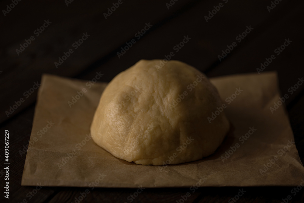 dough on an old wooden table close-up, background for cooking, food photo dough on an old wooden table close-up, background for cooking, food photo