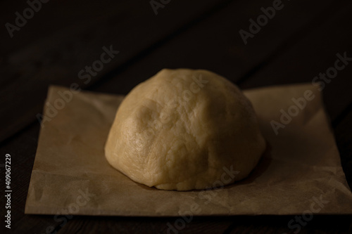 dough on an old wooden table close-up, background for cooking, food photo