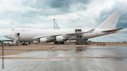 White Boeing 747 400 Freighter carrying cargo at cloudy day