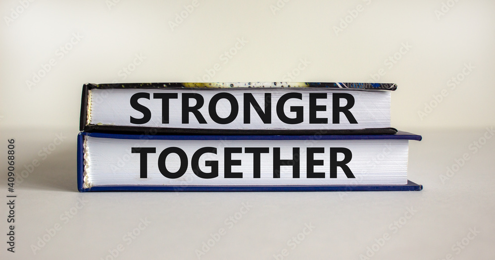 Stronger together symbol. Concept words 'stronger together' on books on a beautiful white background. Business, motivational and stronger together concept.