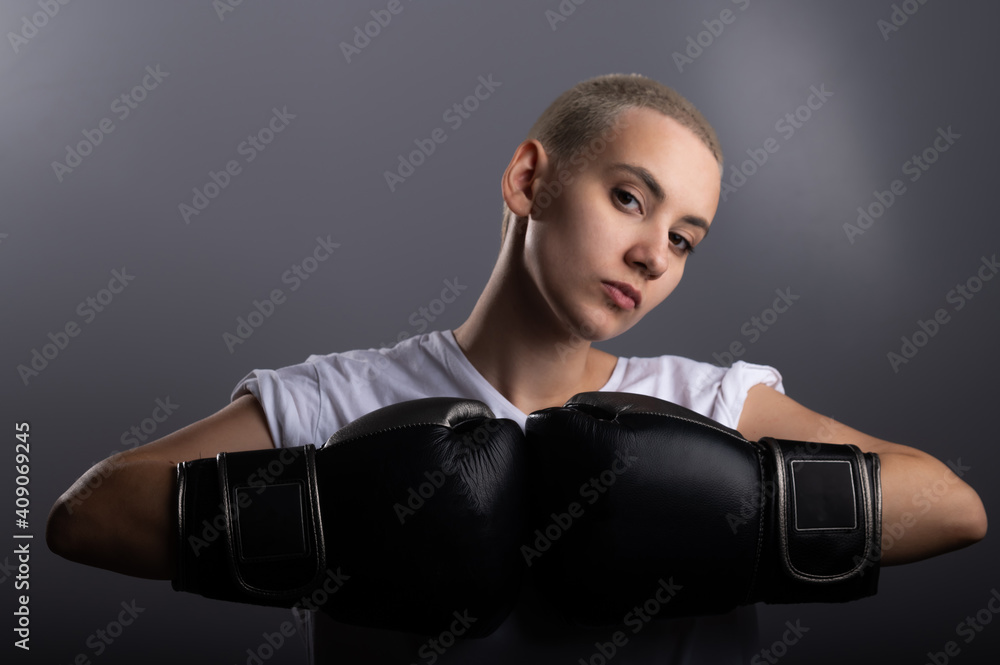 Young woman with short hair in boxing gloves on a white background Young woman with short hair in boxing gloves on a white background
