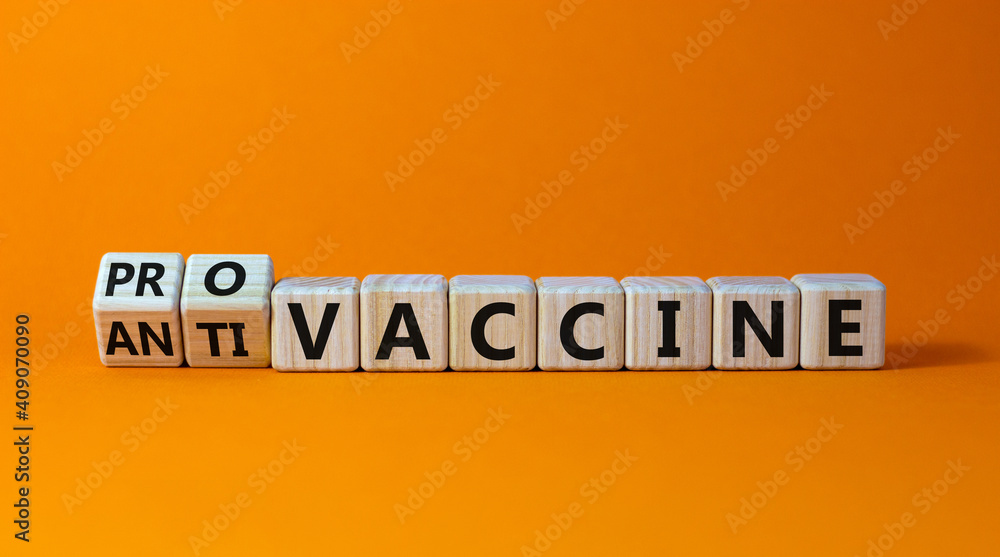 Pro-vaccine or anti-vaccine symbol. Turned cubes, changed words 'anti-vaccine' to 'pro-vaccine'. Beautiful orange background. Copy space. Medical covid-19 pro-vaccine or anti-vaccine concept. Pro-vaccine or anti-vaccine symbol. Turned cubes, changed words 'anti-vaccine' to 'pro-vaccine'. Beautiful orange background. Copy space. Medical covid-19 pro-vaccine or anti-vaccine concept.