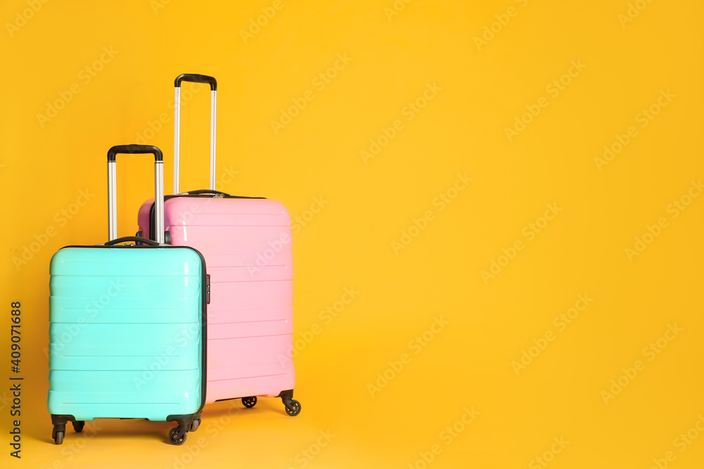 Travel suitcases on yellow background, space for text. Summer vacation Travel suitcases on yellow background, space for text. Summer vacation