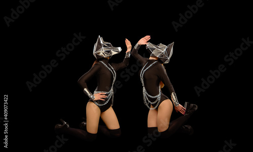 Konstfotografi Two go-go variety show dancers in wolf masks on black
