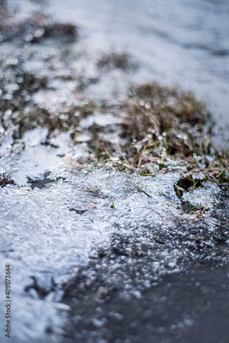 grass frozen in ice, river bank with ice floes, macro, winter landscape, natural phenomena © Olga Mykovych