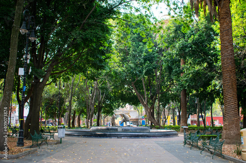 Fototapeta Naklejka Na Ścianę i Meble -  Peaceful park with a fountain and statues in Mexico City