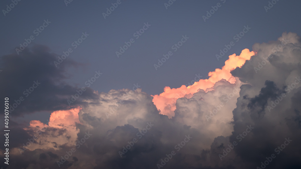 Top of cumulus cloud. Dramatic sky before storm. Cumulonimbus during sunset Top of cumulus cloud. Dramatic sky before storm. Cumulonimbus during sunset