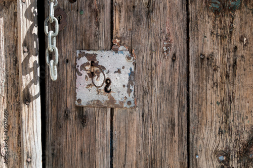 Close-up detail of vintage entrance door panels lock and chain