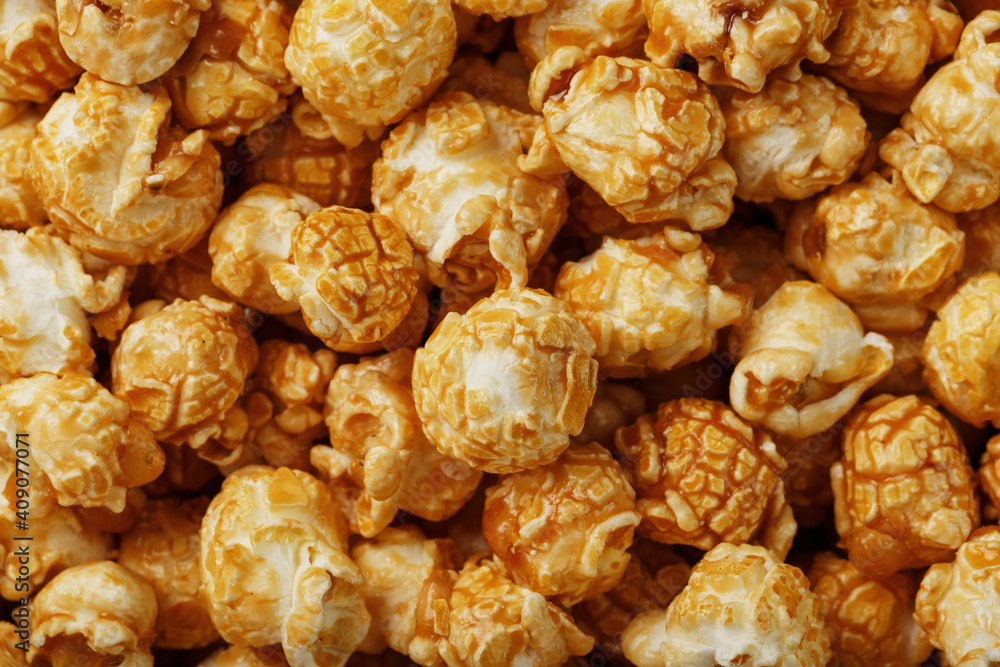 Popcorn in caramel glaze close-up as a background. Popcorn in caramel glaze close-up as a background.