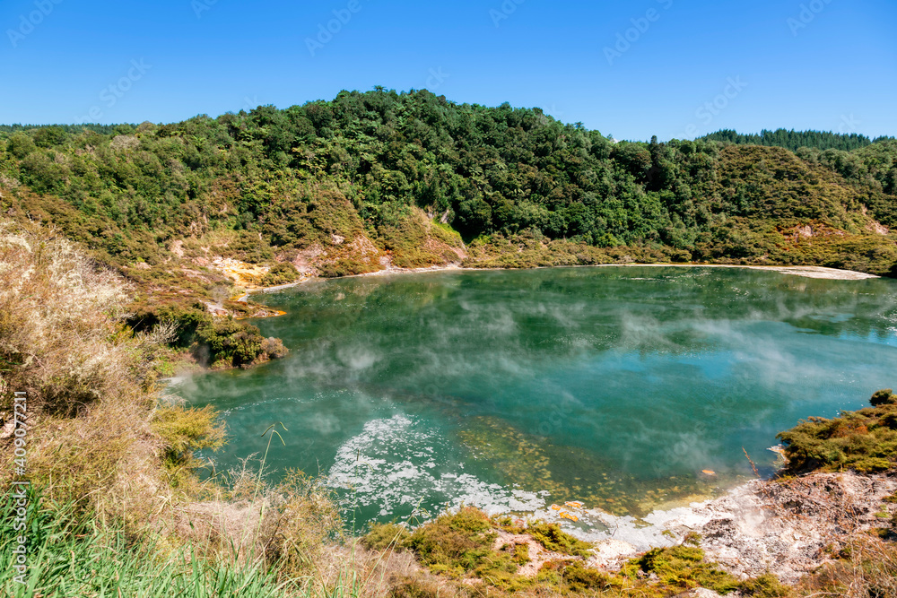 Green crater lake with rising steam in Waimangu Volcanic Valley