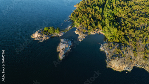 Top down view of rocky island in Saaristomeri. The Archipelago in summer. Beautiful island and pine forest. Drone photo from above. Nordic Nature. Finland. photo