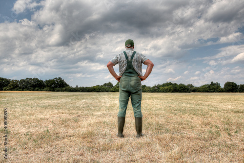 A farmer stands in the middle of his parched meadow, hoping for rain. Rising temperatures, longer periods of heat and too little rain, the arable soil in Germany are dry like never before.