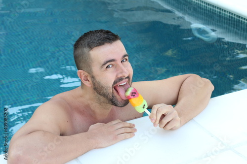 Man enjoying ice cream in hotel swimming pool