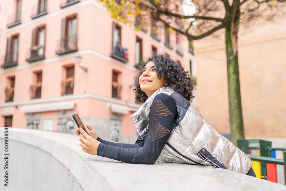 woman enjoying the city and using her smartphone woman enjoying the city and using her smartphone