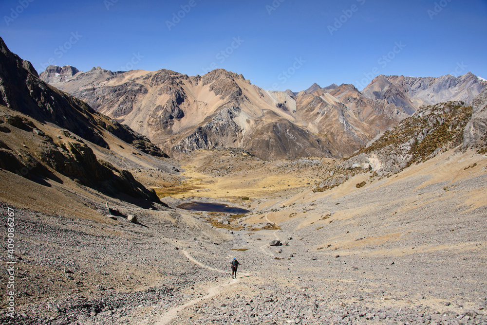 Trekker heading to Santa Rosa Pass towards Sarapo Glacier on the Cordillera Huayhuash circuit, Ancash, Peru