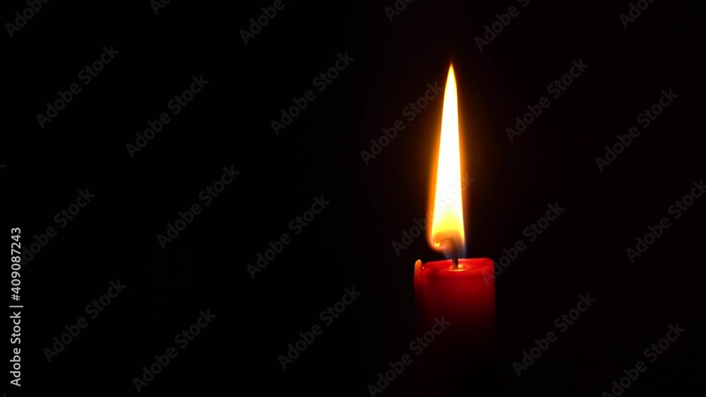 Red candle burns, blown out quickly, relit in dark: space to the left for text. Red candle burns, blown out quickly, relit in dark: space to the left for text.