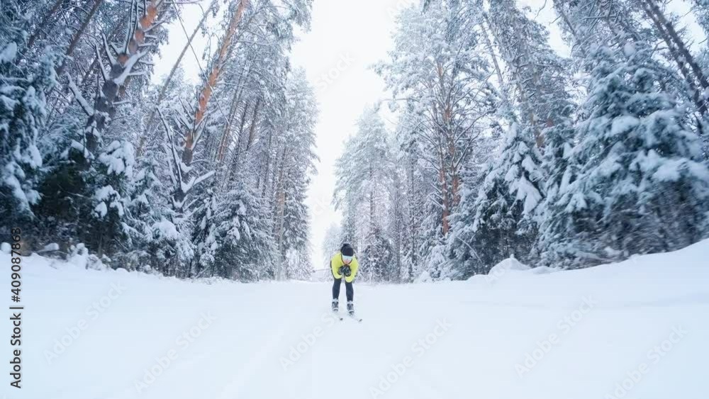 Cross country ski. Woman skier works out on the skating ski track in the winter forest with snow covered trees Cross country ski. Woman skier works out on the skating ski track in the winter forest with snow covered trees