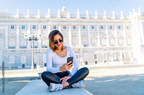 woman sightseeing and using her smartphone photo
