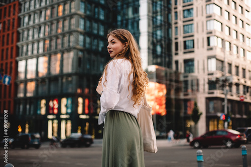 Portrait of thoughtful young woman standing on street in city